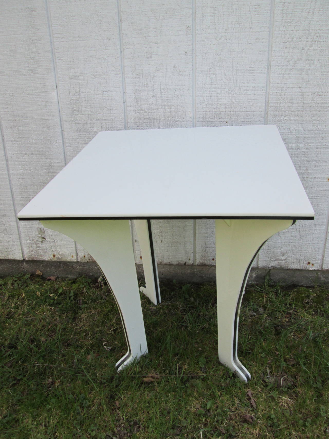 White Lucite side table with black Lucite details.