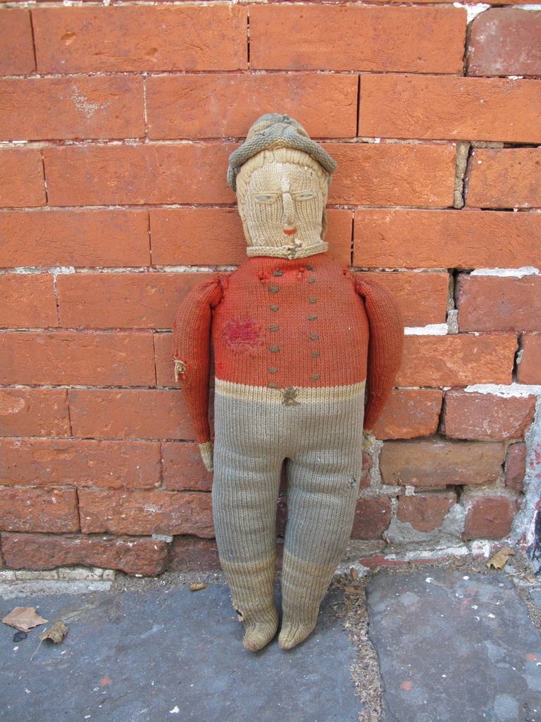 Hand-knit and stuffed with fabric remnants. Repaired by hand as shown.
