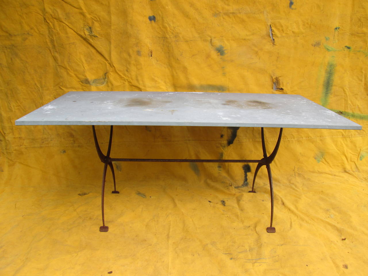 Iron base French table base. Zinc-wrapped top. Note: slightly taller than average dining height.