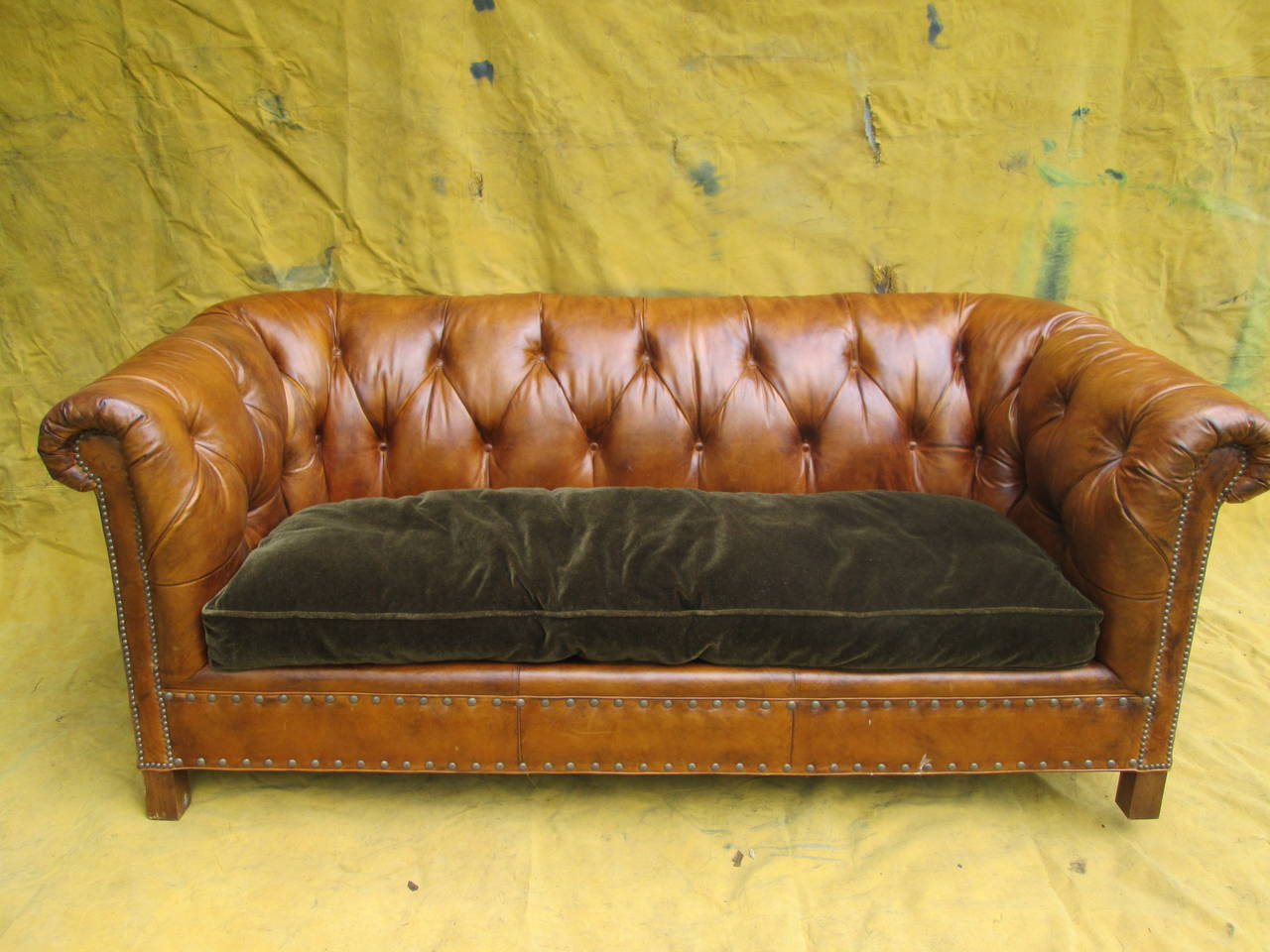 Grand scale tufted cowhide sofa with loose mohair cushion. High rolling arms. Minimal wear to leather. William Alan, High Point, NC.
