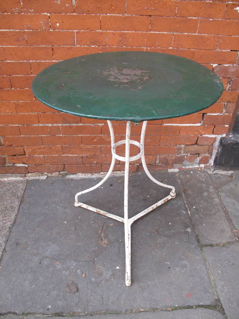 Industrial era French cafe table with green and white paint.