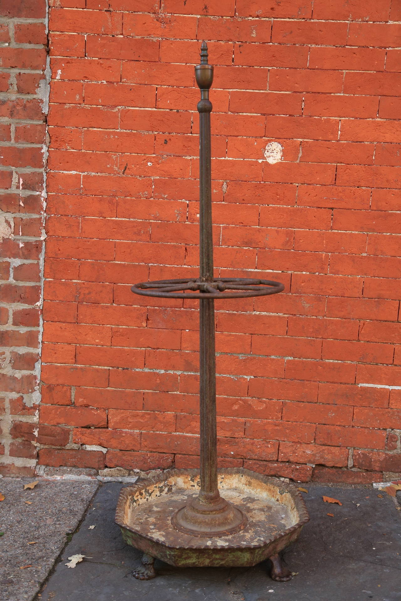 Octagonal cast iron paw footed base. Fluted central post with bronze finial.