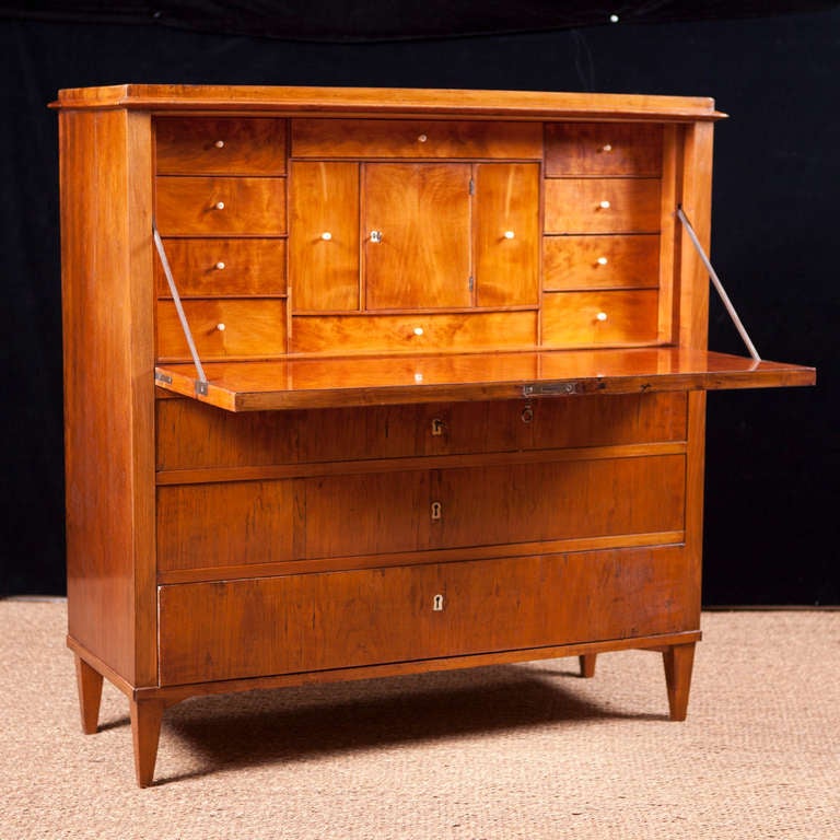 Swedish Gustavian fall front secretary in birch, circa 1800. A beautifully proportioned chest in birch with fall-front desk opening to reveal drawers and compartments with original pulls. The base below writing surface offers three long drawers.