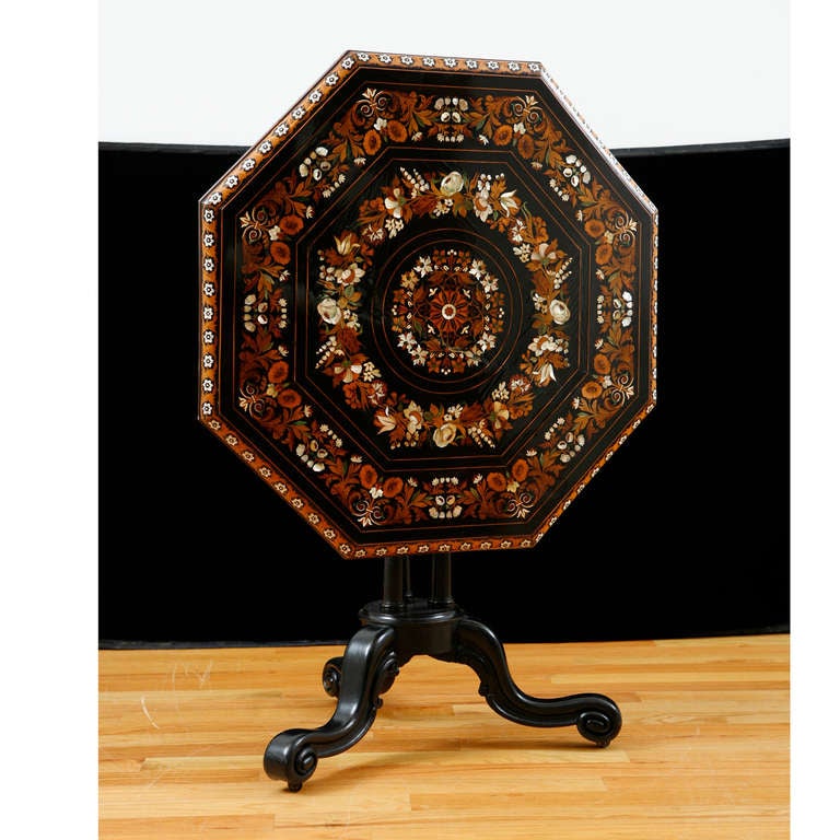 33” diameter x 29” high; 48” when tilted up

Octagonal Tilt-top Table with ebonized center pedestal base and top with inlays of mother of pearl & various stained woods, England, c. 1840. Table is best appreciated as a work or art.  It displayes