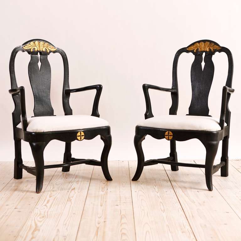 Pair of early 18th century Swedish armchairs in the Nordic Baroque style with original restored ebonized finish. Mortise and Peg construction and slip seat. Back splat and foot are consistent with Queen Ann chairs of that period but of a provincial