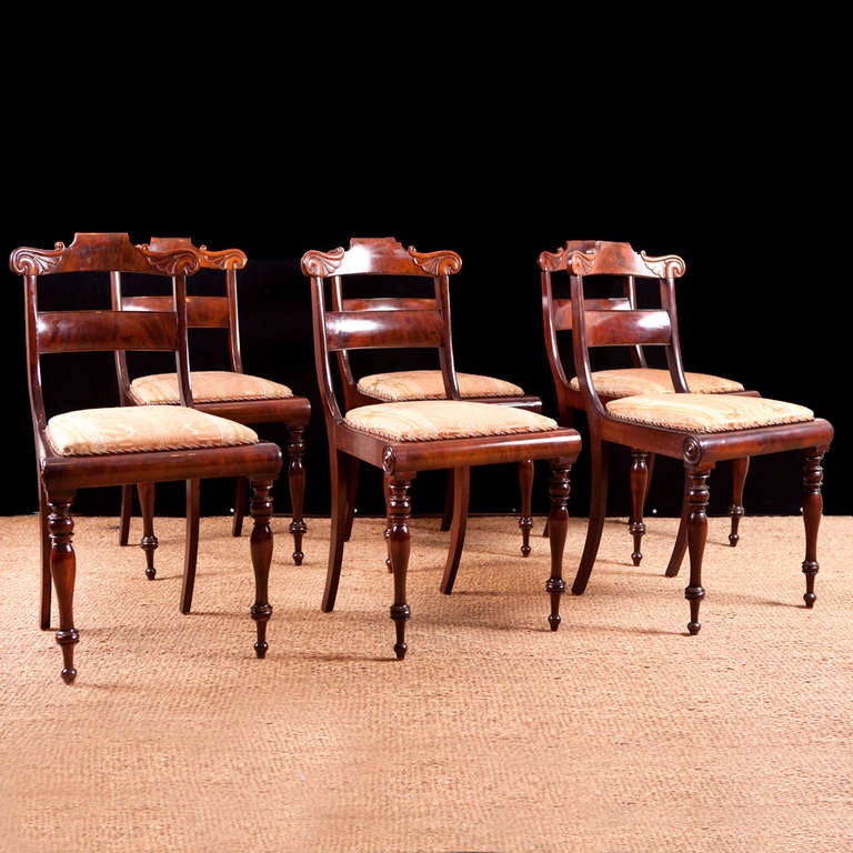 Set of six dining chairs with carved slat back and turned legs. Fabricated during the reign of Christian VIII in Denmark, c. 1835. Typical of a provincial form of the period but in a rich urban mahogany.

Measures: 19