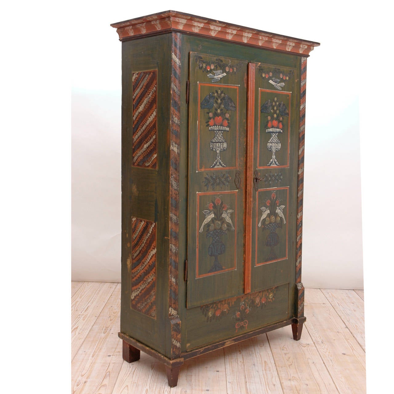 A charming piece of European Folk Art probably from the Alsace Lorraine region, this marriage armoire has the naiveté born of nascent love! With painted panels depicting doves and hummingbirds hovering over stylized urns brimming forth with ripe