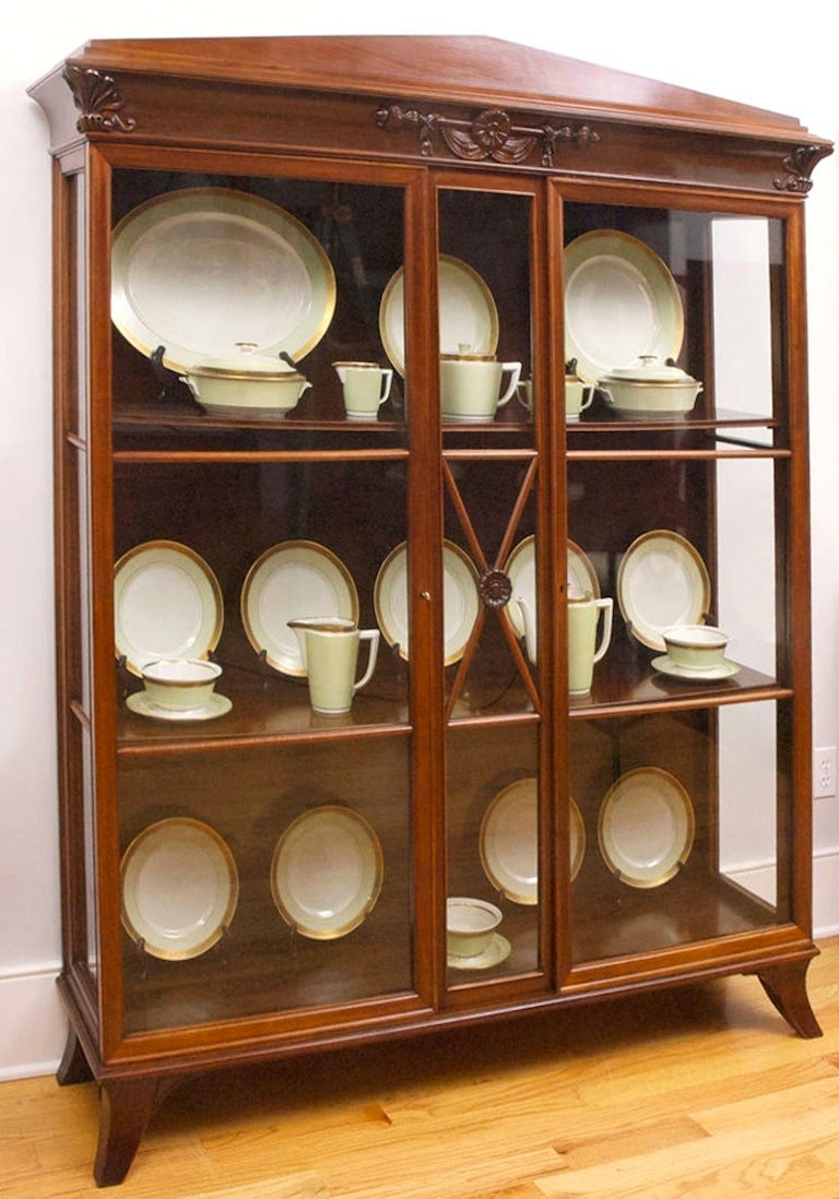 A very fine French Art Deco display case in West Indies mahogany that was manufactured in France for a client in Berlin, circa 1915. Features glass panels on front as well as on the sides, with pediment top and corners embellished with classical