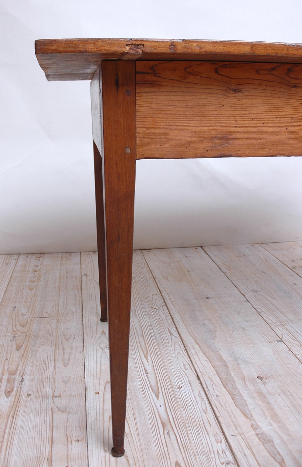 A multipurpose farm table in pine with square-tapering legs. Features mortise and tenon pegged construction and a beautiful rich patina acquired over its two centuries-long history, Europe, circa 1790.
Measures: 46 1/4