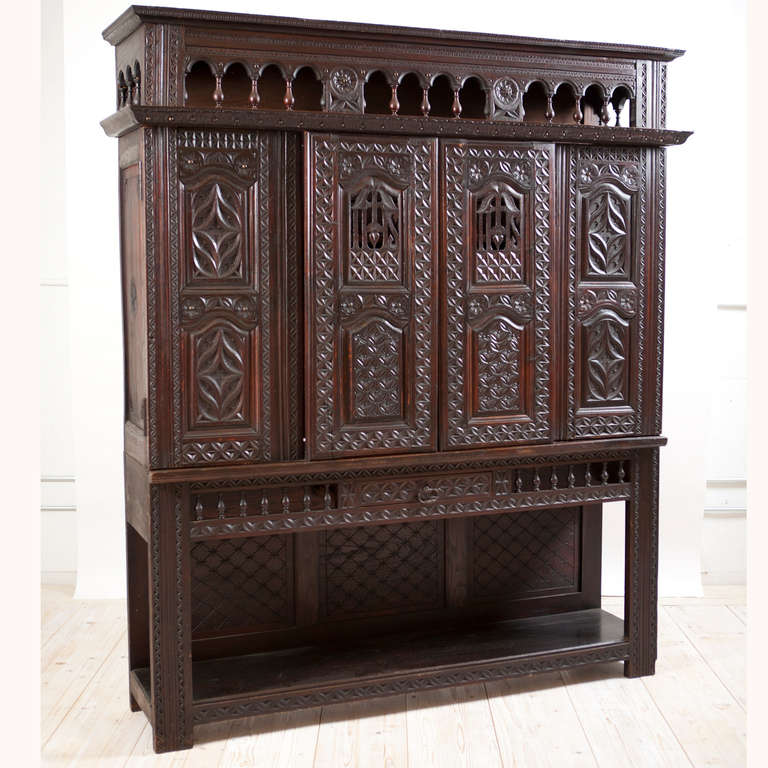 A Renaissance Revival cupboard or vaiselier in the style of Louis XIII from Brittany, France, circa 1890. In a richly dark, carved French oak with sliding doors in the center flanked by two hinged doors at either side, offering lots of storage. Open