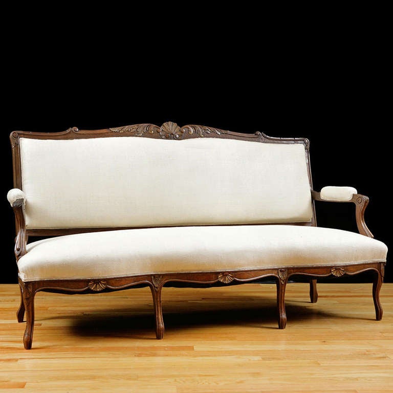 La Belle Époque LXV Style Sofa in carved walnut, France, circa 1870
Louis XV style canape or sofa in walnut, with gilded details in carvings of scallop and acanthus leaves on back crest, with carved cabriole legs and carved scallops on apron.