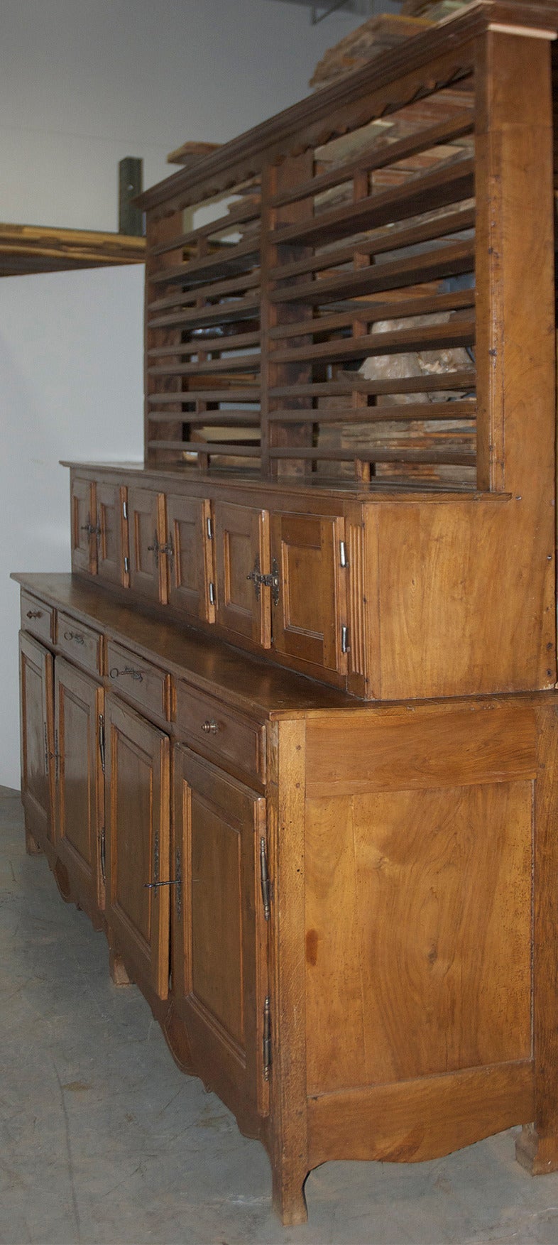 A rare and unusually long French, Louis Philippe Vaiselier or Cupboard in cherry wood offering a variety of storage uses. Features an open dish rack over six locker-like cabinets that rest over a long buffet consisting of four drawers over four