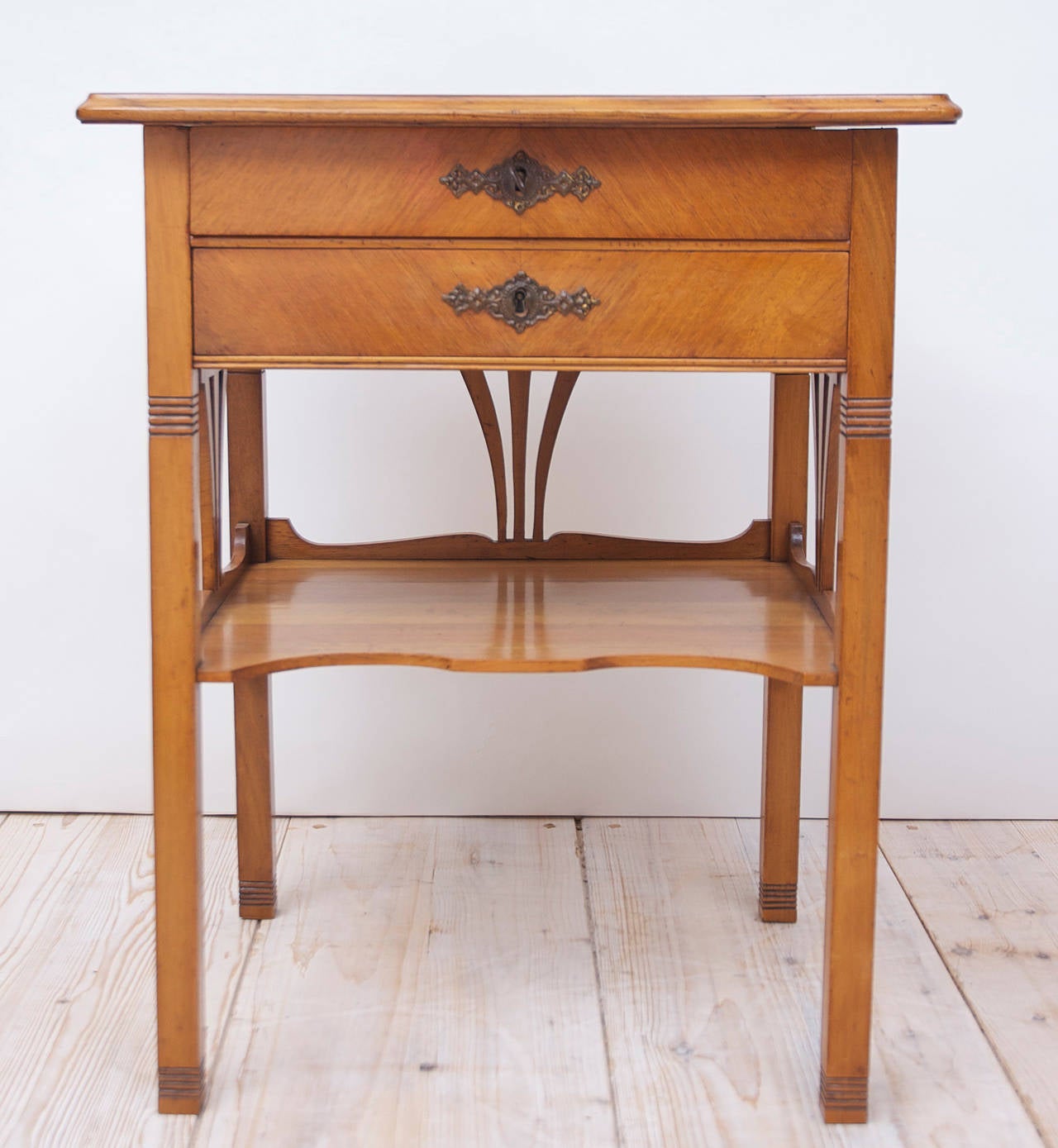 A fine Art Nouveau side table in walnut with parquetry top and drawer fronts. Offers a bottom shelf and two drawers with lift-top, Continental Europe, circa 1890.
Measures: 21