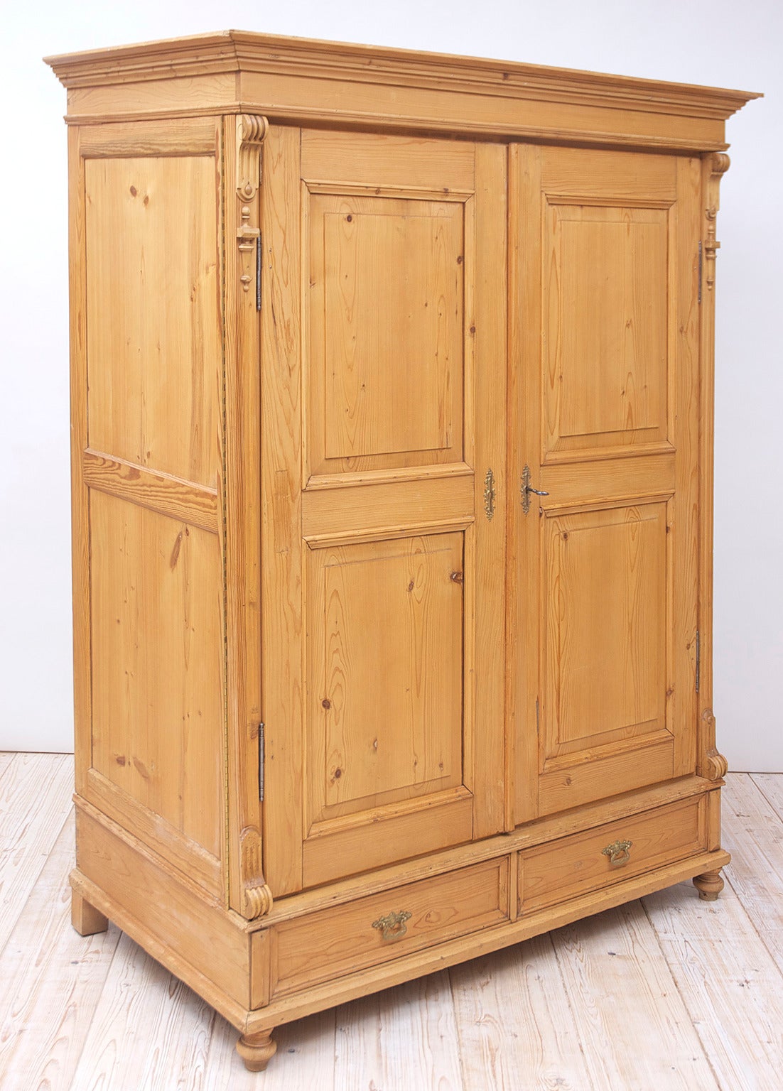 An unusually deep armoire in pine with paneled doors and sides. Features a second set of hinges that allow doors to open fully and hug the sides, Germany, circa 1880. Offers lots of storage potential!

Note: There are two lower drawer faces only.