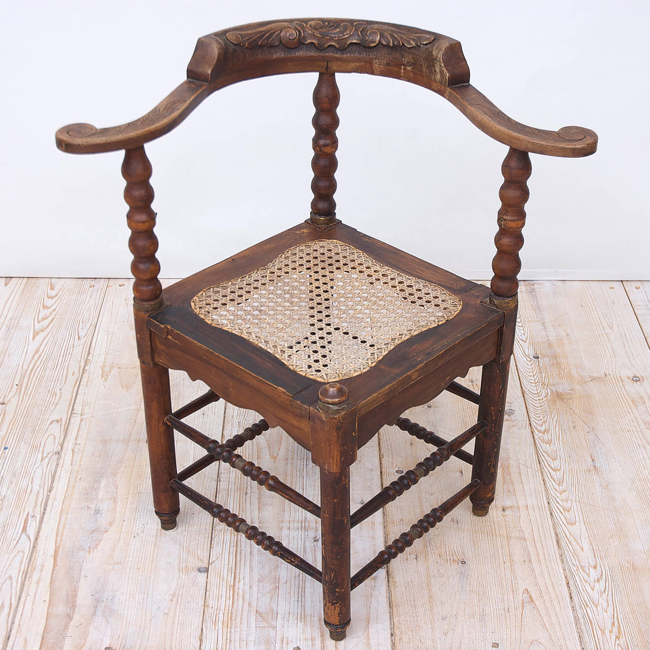 A Dutch colonial corner chair from Dutch Guiana (Suriname) in turned and carved painted wood with caning, circa 1800.
Measures: 28