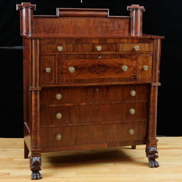 A beautiful example of an early American Empire full column front stand up butlers desk. Ample storage as a chest of drawers and serves as a secretary with additional small drawers in the interior. Well articulated claw feet and original removable