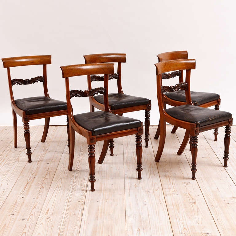 Set of four English William IV rosewood side chairs with black leather slip seats, circa 1830. With Regency scale and proportions. Well articulated carved back splat. Beautiful rich patina, original finish, solid construction. Chairs are very