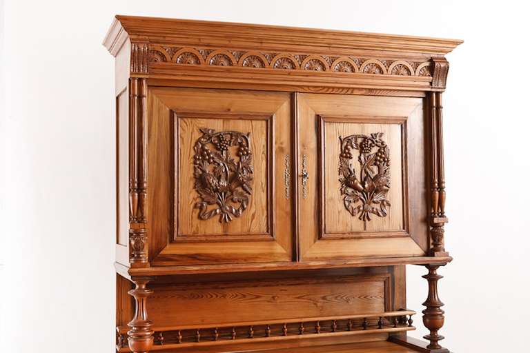 French harvest buffet in pitch pine from the region of Brittany, circa 1860 with intricately carved panels depicting duck, fruit and foliage.
Perfect as a storage cabinet/buffet in your kitchen or dining area.
Materials & Techniques: Pitch pine is