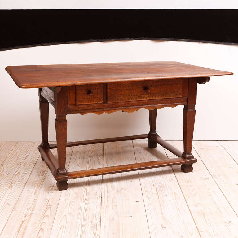 An exceptionally beautiful farm house table from the Tyrolean region of Austria in fruitwood with the rich patina of age acquired from its 250 year history! A multipurpose table, it would have served as a dining table as well as a table used in the