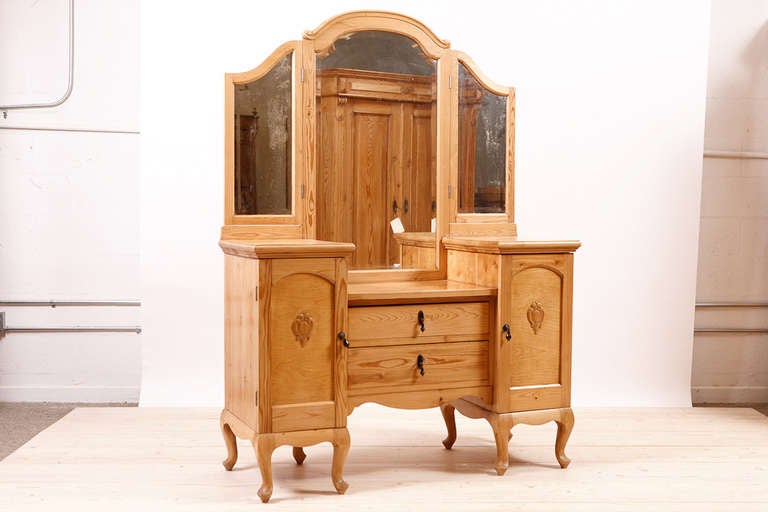 Art Deco Dressing Table in Pine, c. 1920. Original Bakelite pulls, mirrors and applied carved embellishments on door panels. Can be painted upon request.