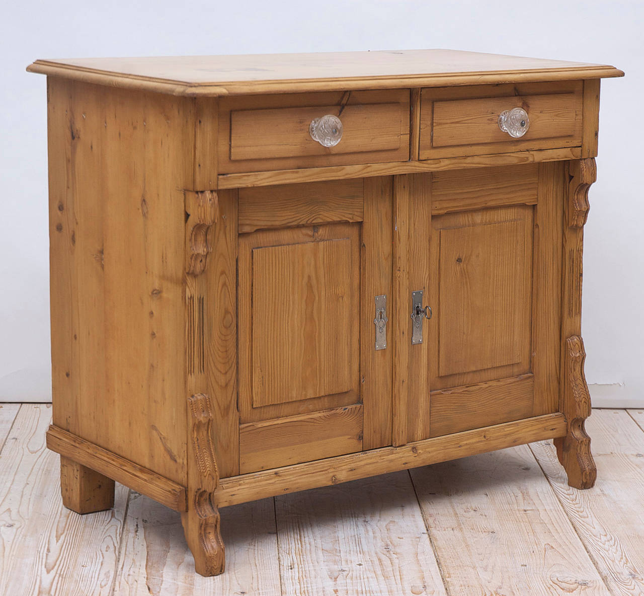 A Louis Philippe cabinet or cupboard in pine with two drawers above two cabinet doors, with nickel key plates and glass knobs, German, circa 1860. A charming informal night stand or bathroom vanity for use with a sink!

Dimensions: 39 1/4"