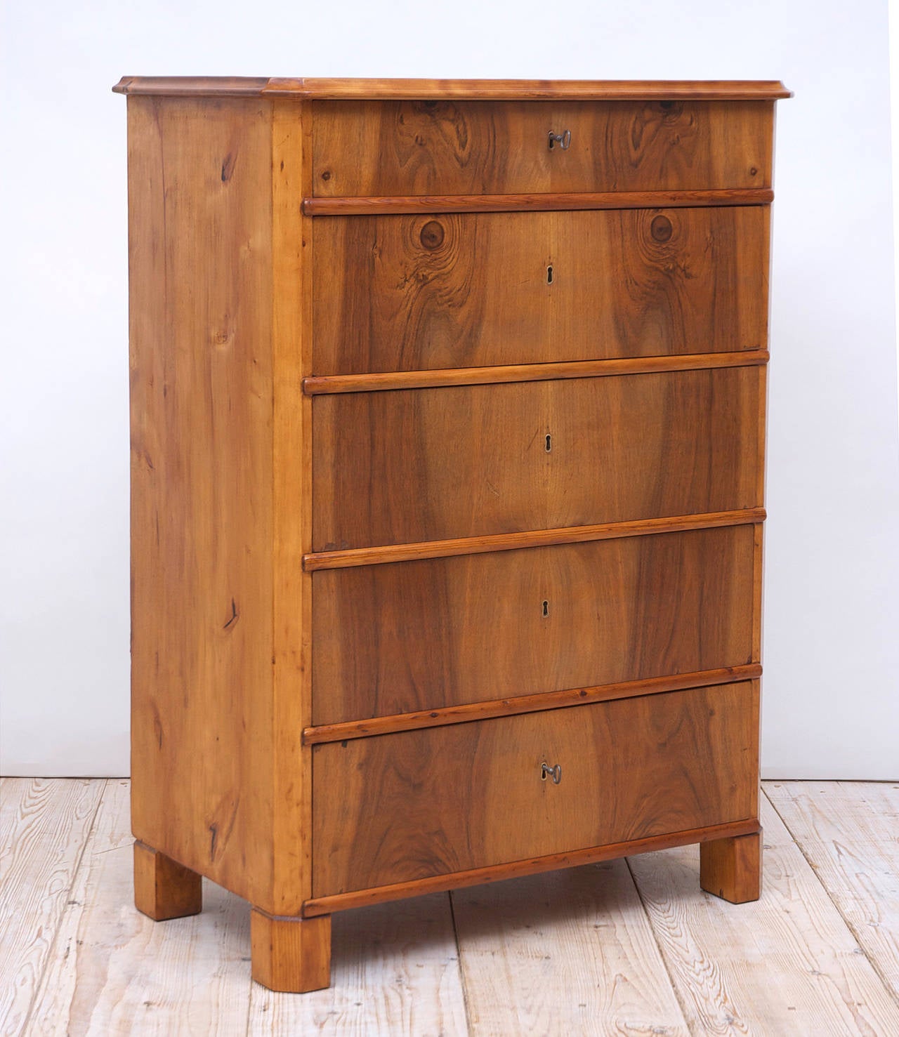 While the clean, almost contemporary lines of this piece can be disarming in its seeming simplicity, what is so captivating about this handsome chest, is the configuration of 