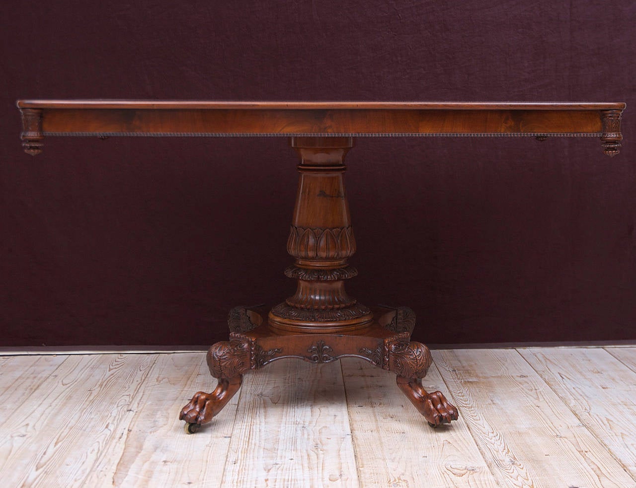 A very lovely and beautifully-crafted salon or sofa table in West Indies/ Cuban mahogany with rectangular top over acanthus-carved, baluster-turned column, resting on quatre-form base with carved lions paw feet, Denmark, circa 1825. 
Note: May also
