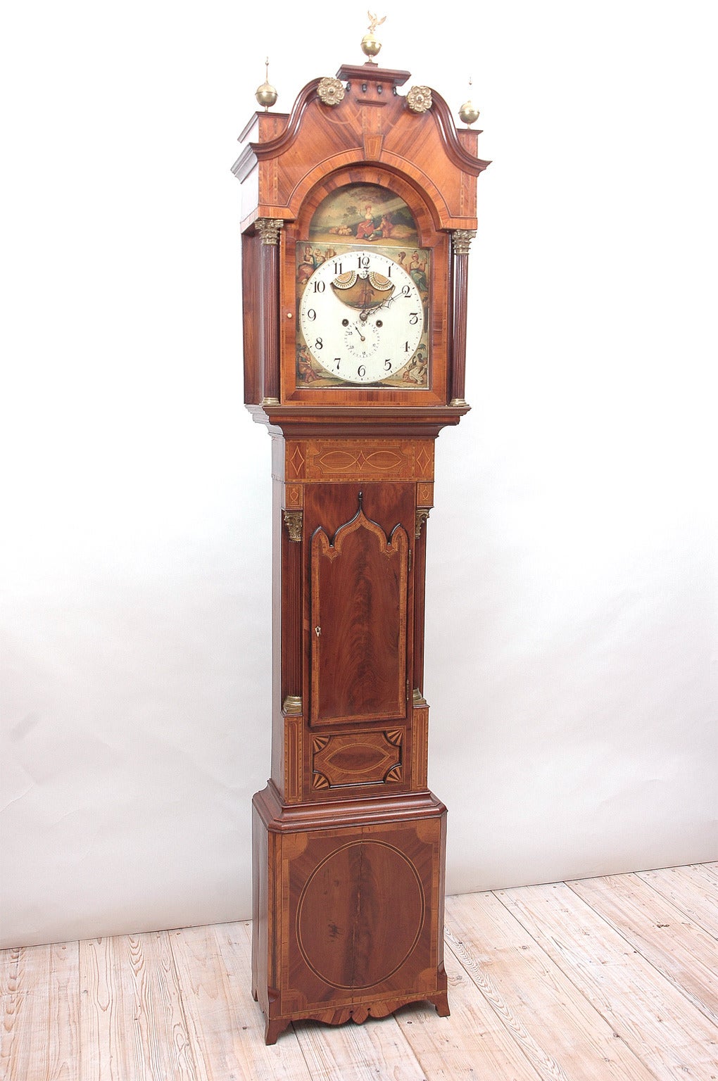 English Regency 8 day tall case clock. Clock maker unknown, dial was painted by Finnemore of Birmingham. The name is engraved onto the back of the calendar dial and stamped or cast into the mounting plate. The Finnemore family painted dials from