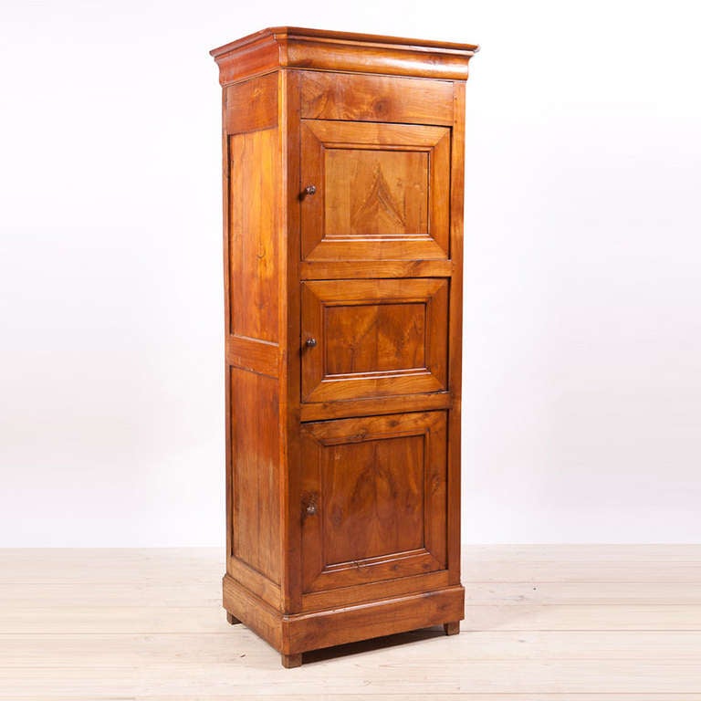 French provincial Louis Philippe three-door cupboard in solid wild cherry, circa 1835.

Measure: 28" wide x 20 1/2" deep x 82" high.