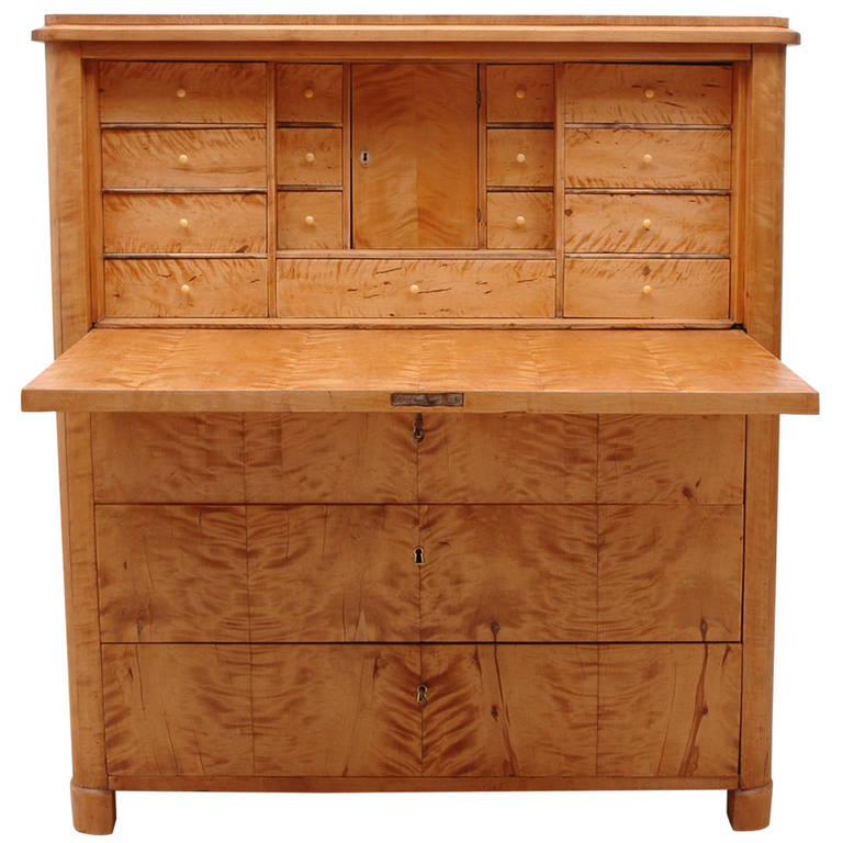A handsome fall front secretary in birch wood with a light relaxed finish. The fall-front opens to a desk with a series of 15 small drawers and a central cubby. Below the desk are three large exterior drawers, Sweden, circa 1830. The clean lines and