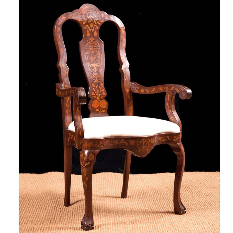 A late 19th century New York armchair in the early 18th century Dutch-Style in mahogany decorated with inlays in other woods of bows, birds, rinceau of flowers and foliage, with a solid vase-shaped splat, drop-in seat, and cabriole legs with
