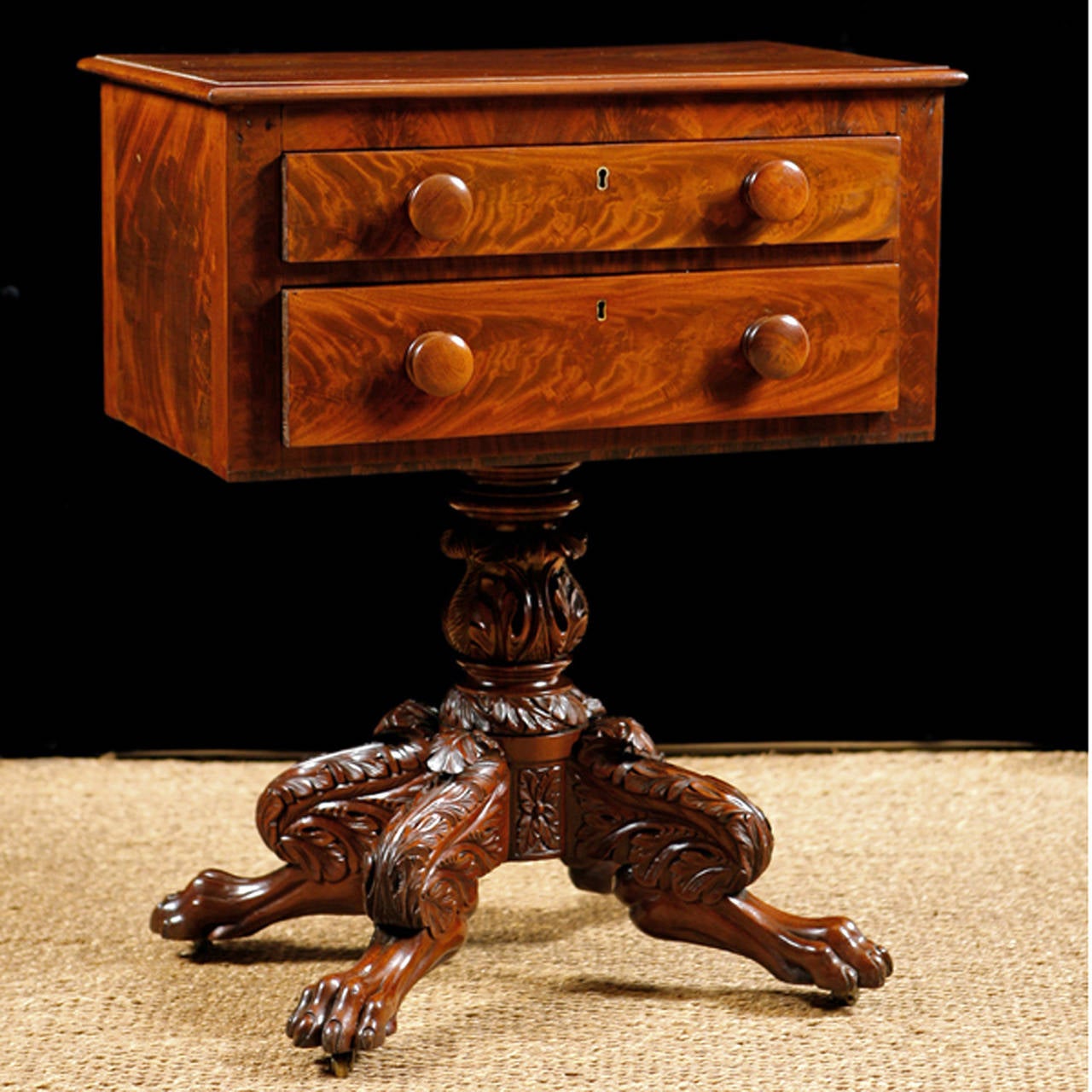 A very fine Federal work table with two drawers on pedestal base with baluster-turned and carved column resting on acanthus decorated lions' paw feet. The carvings are very well articulated and show exceptional workmanship. Offers original turned