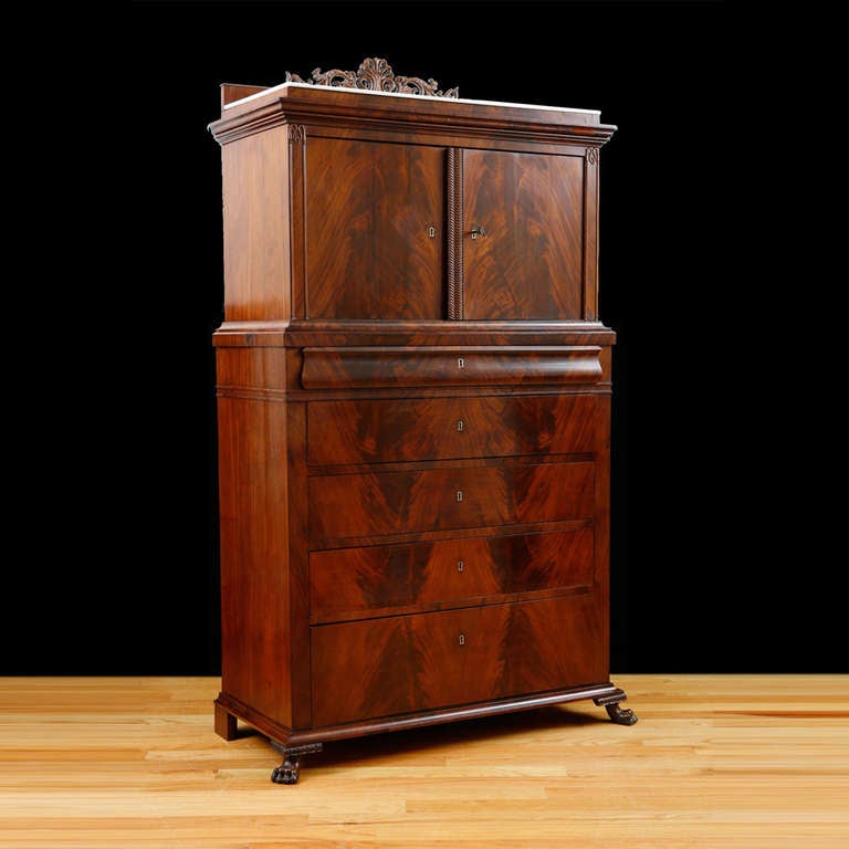 Danish Silver cabinet In Fine Cuban mahogany with bookmatched figurative mahogany, original Carrara marble over cabinet doors atop five drawers resting on carved lion's paw feet. Fabricated during the reign of Christian VIII of Denmark, circa 1845.