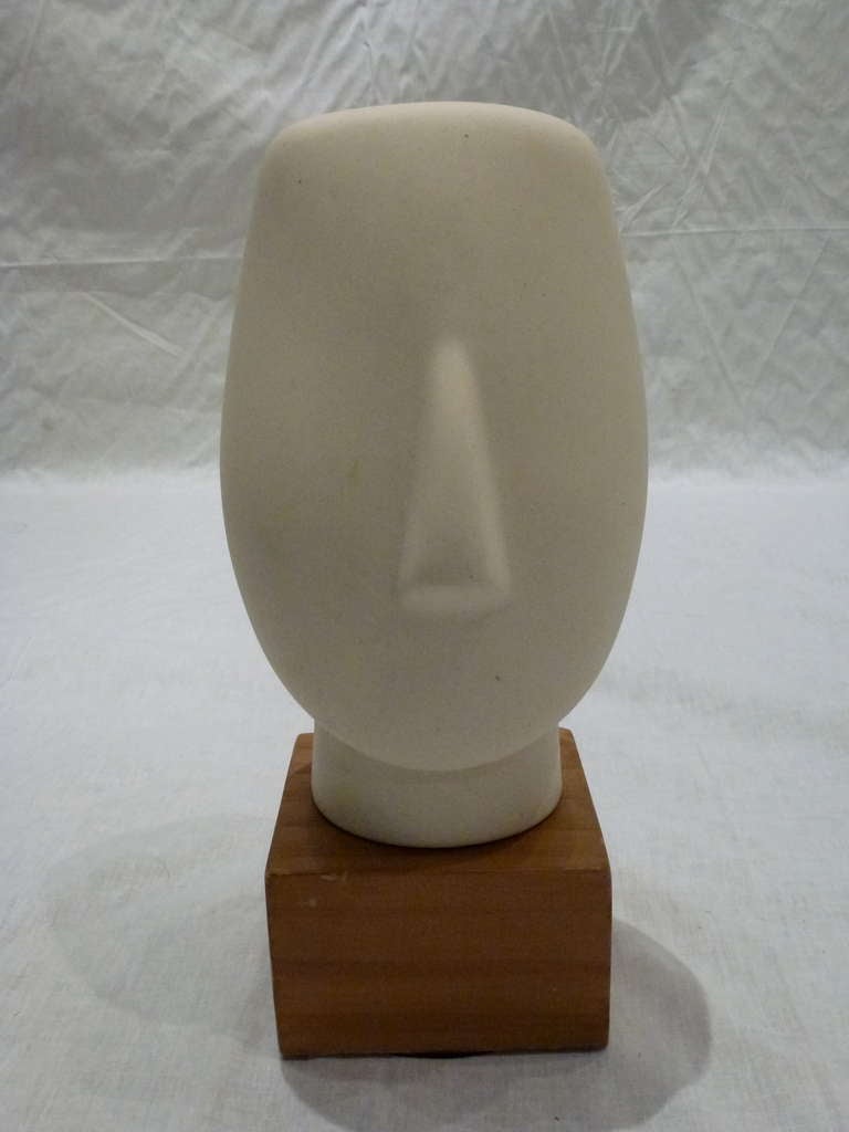 Striking Set of 2 Mid-Century Faceless Abstract Head Sculptures Reminiscent of the Primitive Style of Ancient Cyclodic Figures.  Both Pieces are Bisque Porcelain on Natural Solid Wood Bases.  One Depicting a Man, the other a Boy.

4