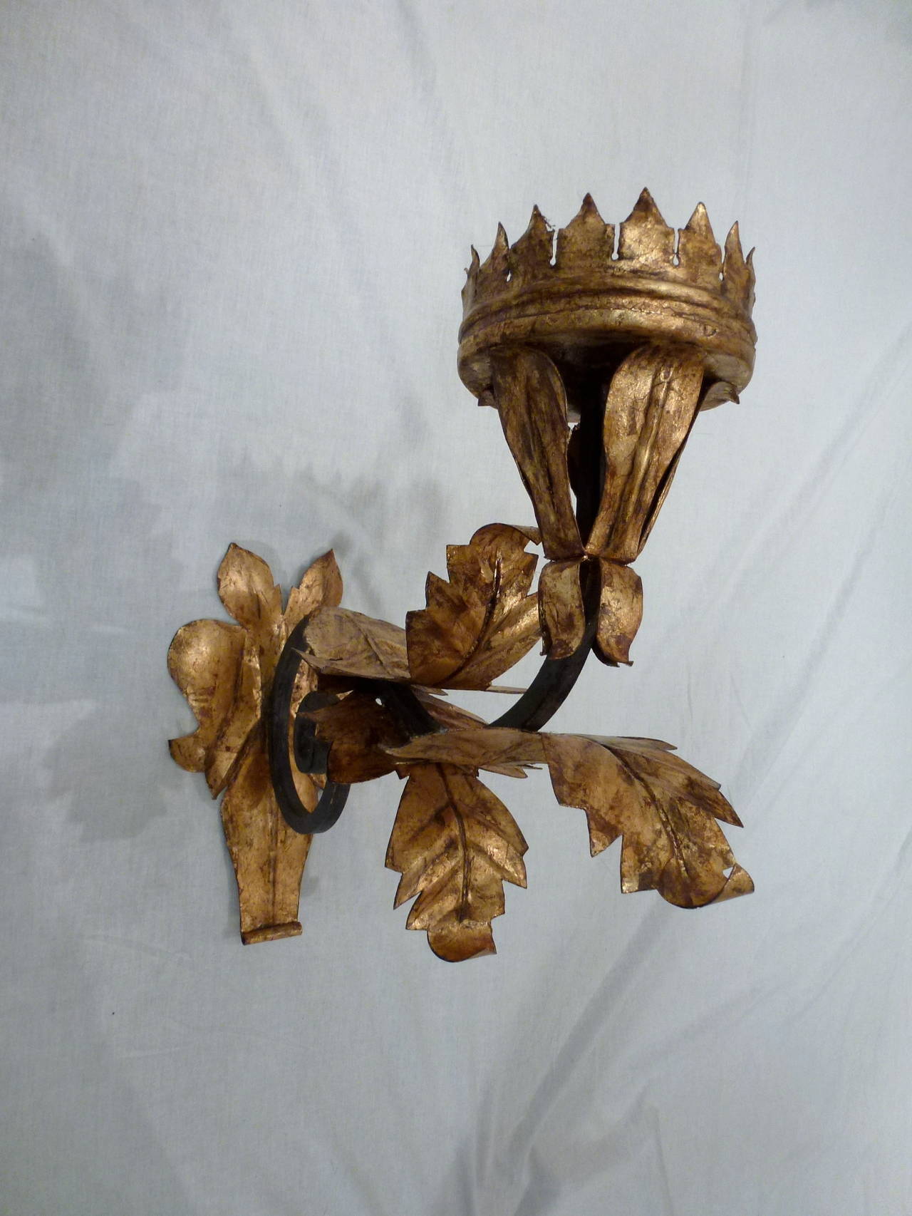 Incredible pair of Antique Italian Rococo style pricket candle wall sconces from the 19th century. Hand-wrought with gold leaf detailing and a wonderful patina. Each piece formed by hand. Designed to hold a pillar candle.