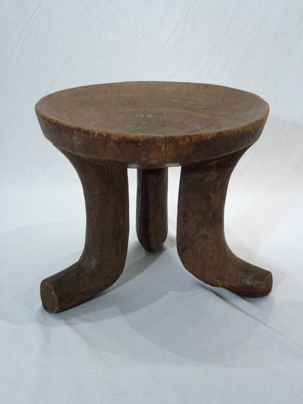 Beautiful Set of 2 African Hand Carved Stools from Ethiopia.  The Taller Round Senufo Stool Features 3 Flared Legs and a Concave Seat.  The Low Senufo Stool Boast 4 Thick Legs and a Wide Rectangular Seat. Each are Hand Carved from a Single Piece of