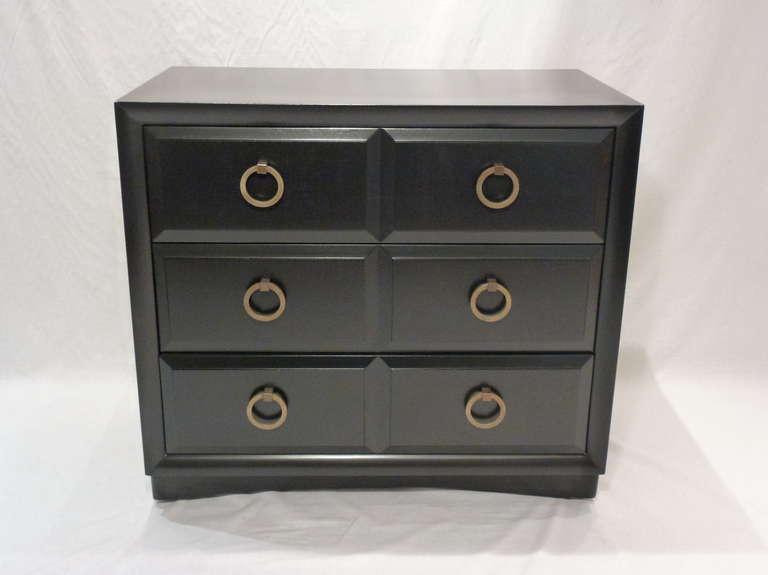 Elegant and Classic Chest Designed by T.H. Robsjohn-Gibbings for Widdicomb.  Beautiful Black Lacquered Finish with Signature Brass Ring Pull Hardware.   3-Drawers. On Casters.  This Beautiful and Timeless Piece will Compliment any Space. Makers Mark