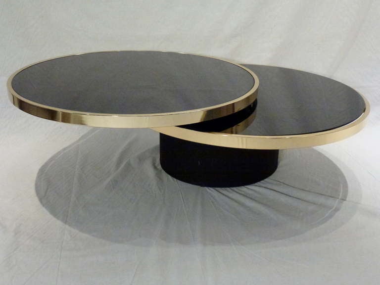 Stunning Italian Brass Trimmed and Black Glass Swivel Top Coffee Table with Upholstered Barrel Base. Top Tier Rotates 360' and can be Reconfigured as Desired.  Extremely Versatile! Base is stabilized with a marble insert.
1970s