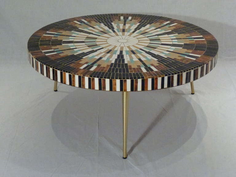 A Magnificent Mid-Century Mosaic Tile Coffee Table by Richard Hohenberg for Hohenberg Original.  Three Solid Brass Tapered Legs Support a Round Sunburst Patterned Mosaic Top.  Gold Metallic Tiles Add Elegant Shimmer. Incredibly Beautiful!