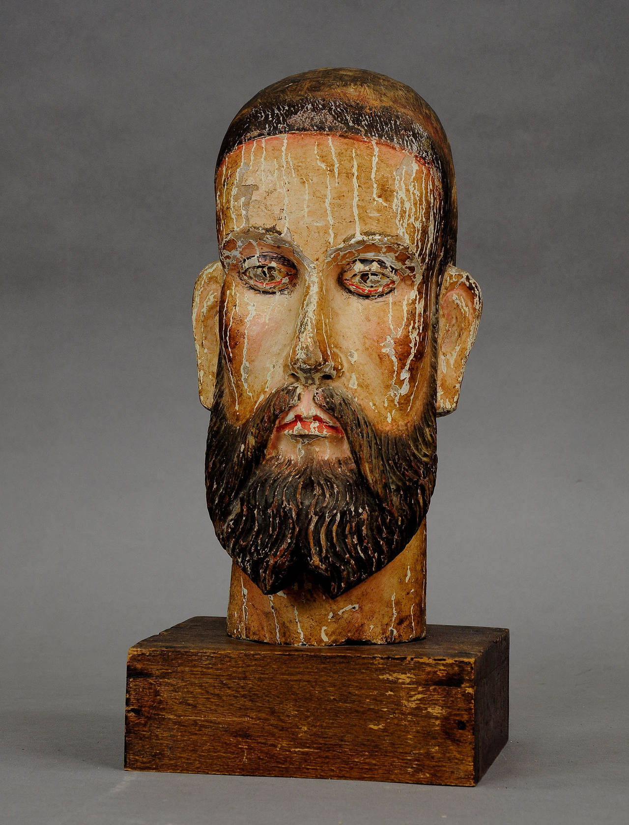 an Armenic ? 16th century carved and painted head of christ, mounted on a new wood pedestal. (unrestored condition, painting partly flaked off)