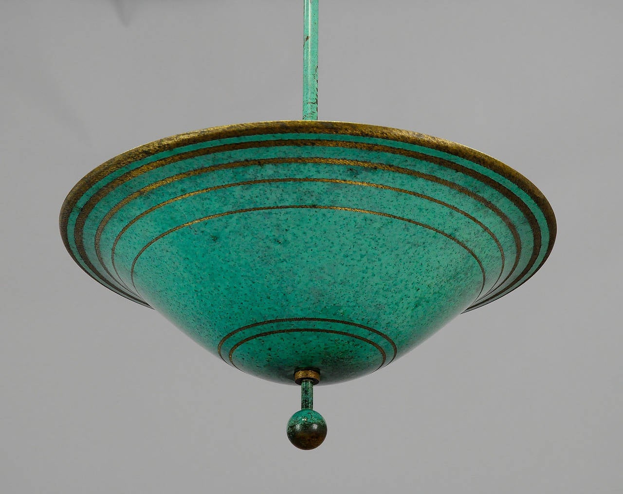 A rare WMF Ikora ceiling lamp. Made of green patinated metal with etched ring decoration in the manner of the class Richard Riemerschmid. Complete extant, with the original glass inset to reflect the light. Executed in the 1930s by WMF