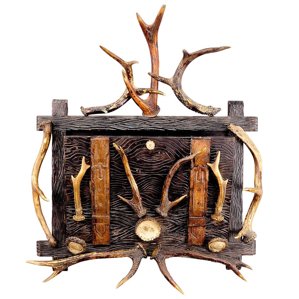 antique black forest newspaper rack with antler decoration