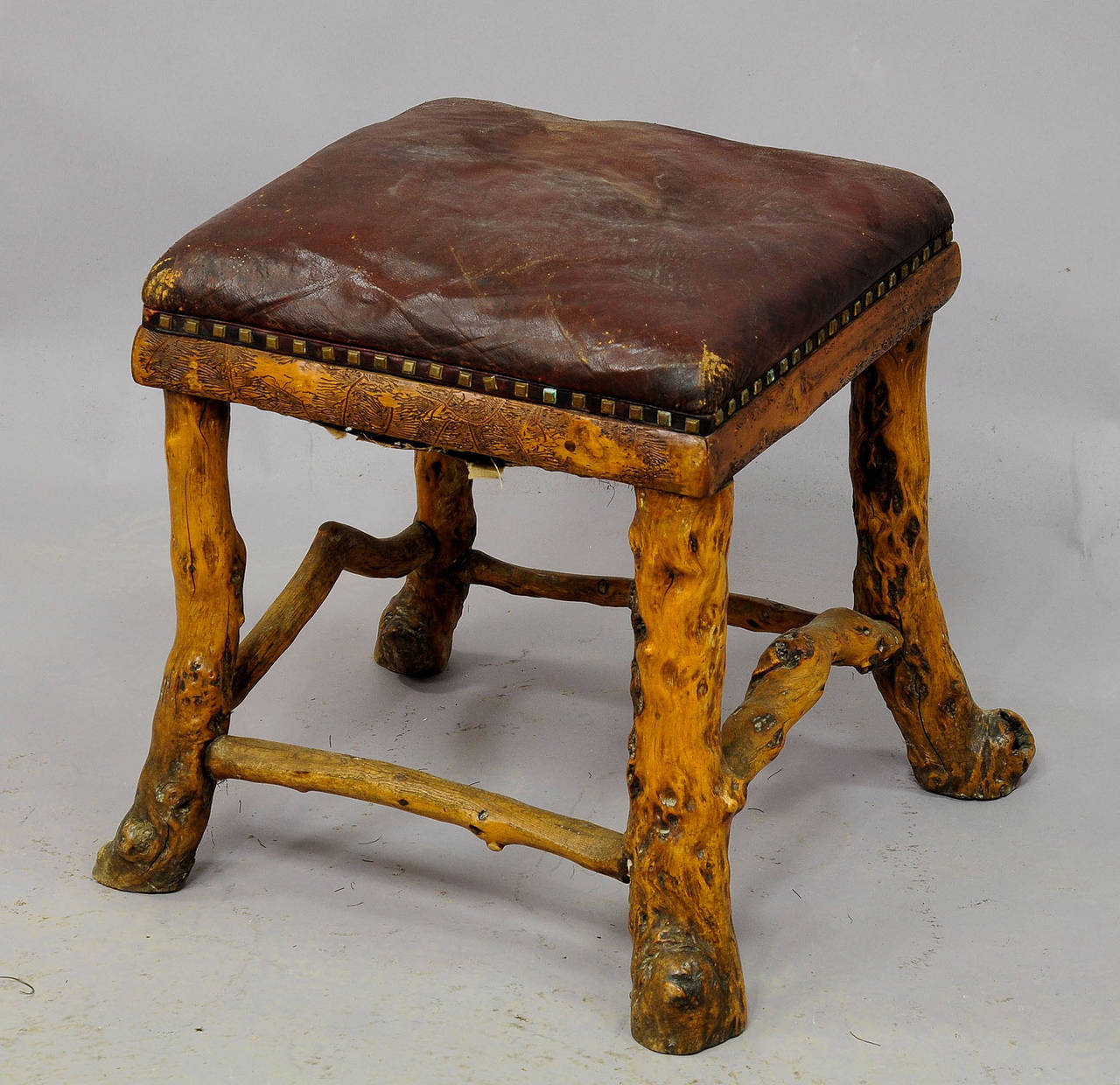 a nice antique stool made of root wood. upholstered and covered with genuine leather. germany, ca. 1900