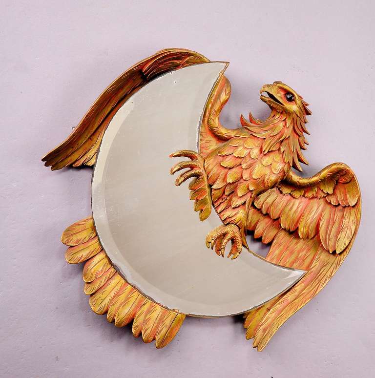 a handcarved and painted wood eagle holding a half-moon shaped mirror. backside with inscription hochzeitsreise 1921 (honeymoon 1921). small woodpiece near the head missing.