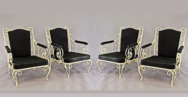 a set of four vintage garden armchairs. made of ornamental iron. new painted and upholstered with black fabric.