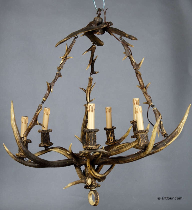 a wonderful chandelier made of antlers from the deer and fallow deer and horn pieces. six lamp tubes in the design of candles. executed ca. 1900.