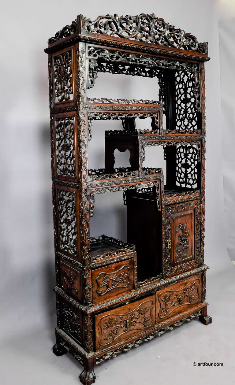 an elaborate carved wood chinese bookshelf. produced in china ca. 1900 for the european market.