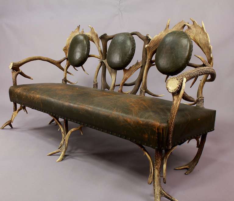 antique antler couch with three seats. original leather cover. executed ca. 1860.