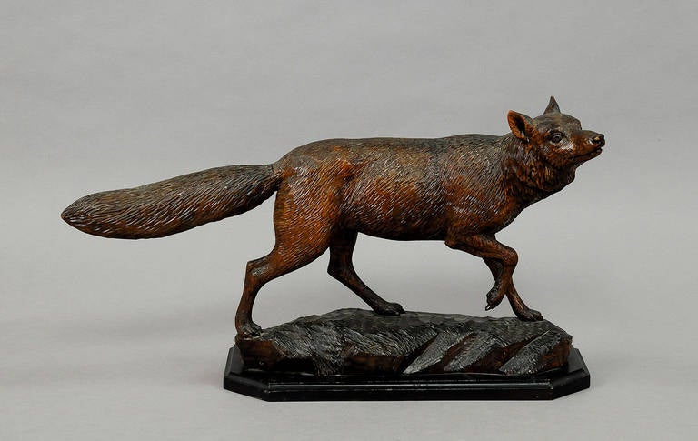 A grandiose black forest hand-carved wood fox. executed by the famous Austrian wood carver Ernst Heissl circa 1900. base with artists signature.