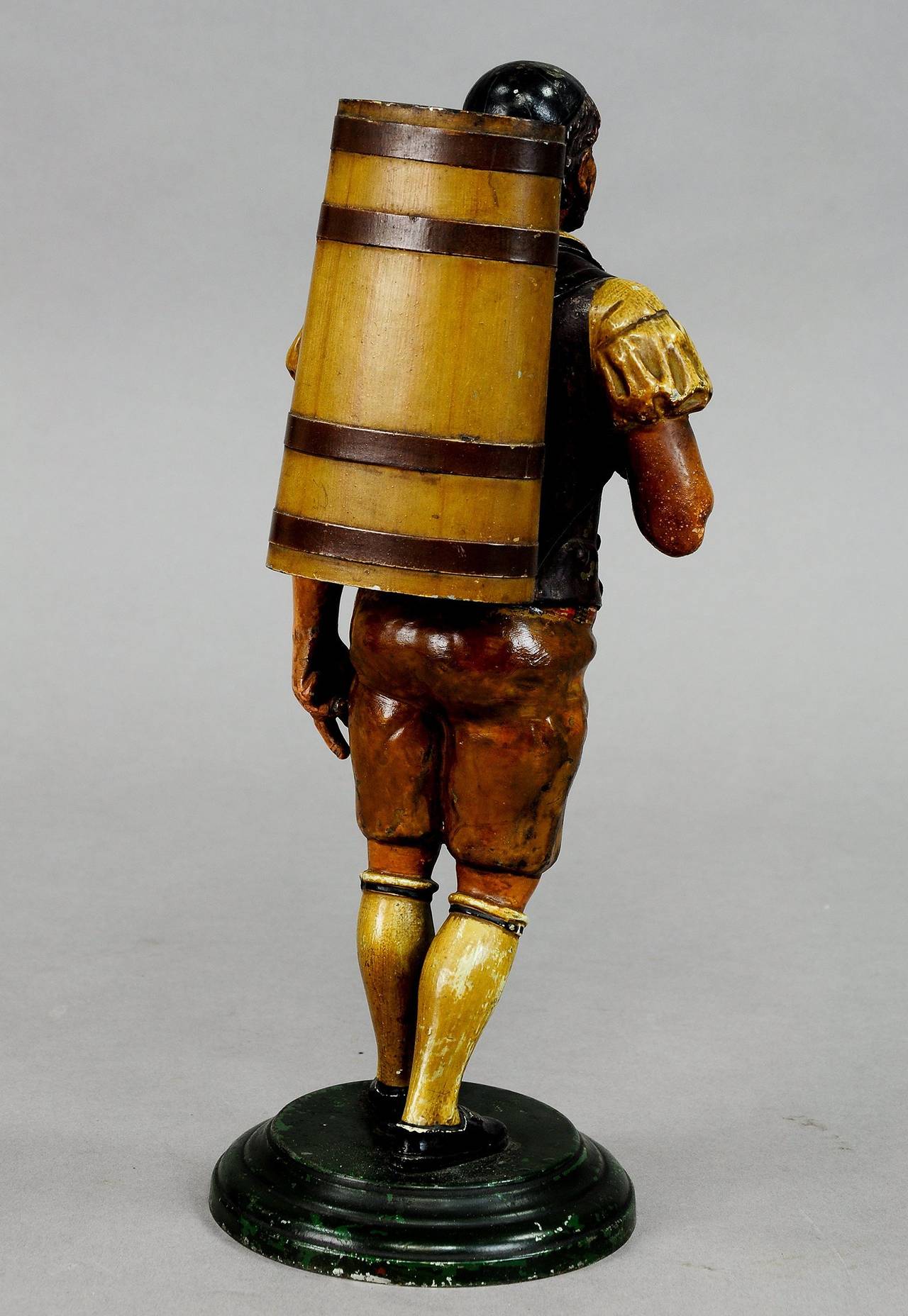 A rare hand-painted tin figurine of a winegrower with pannier, very expressive with fine painting. Trousers partially overpainted, Swiss, circa 1900.